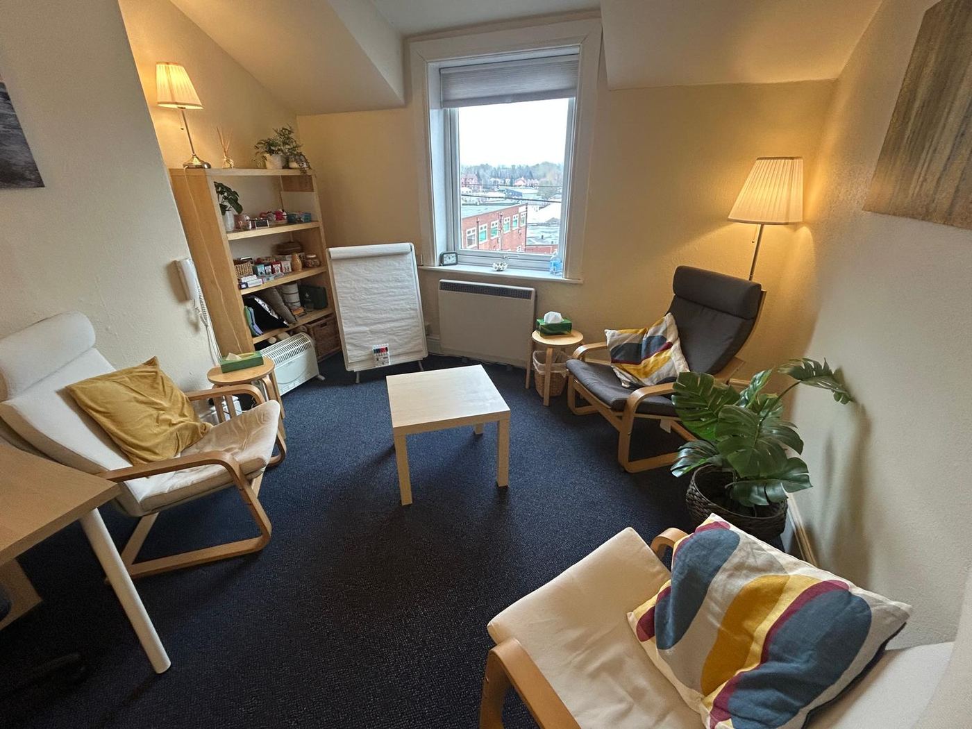 Counselling room with armchairs and soft lighting